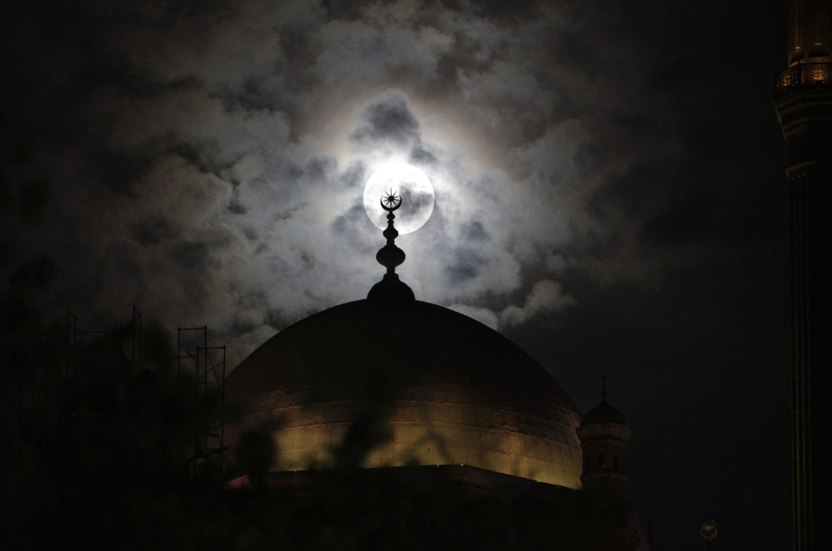 moon behind mosque